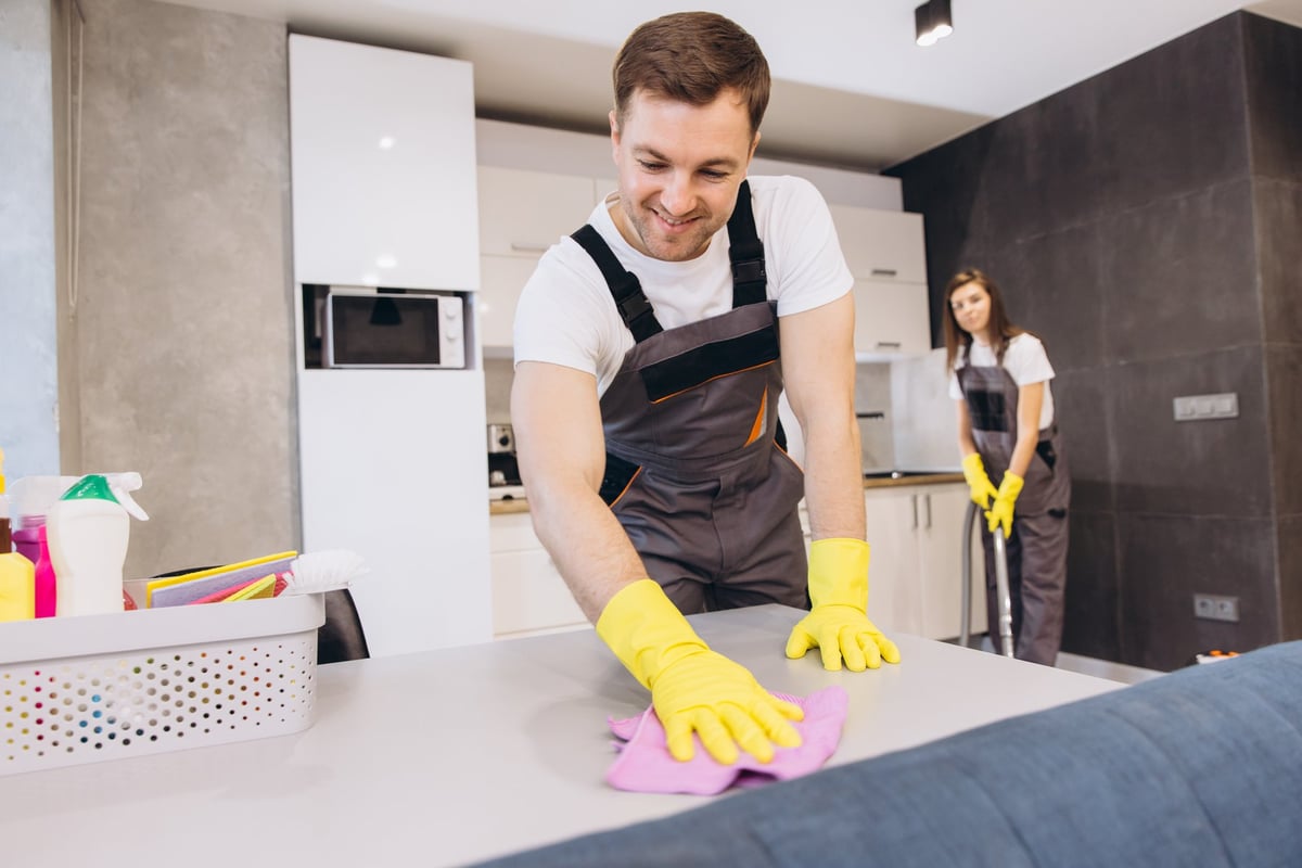 Professional house cleaning service team cleaning modern home kitchen