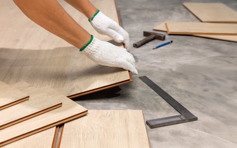 Worker installing laminate floor