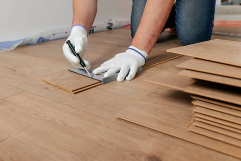 Worker measuring flooring
