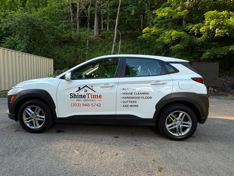 White ShineTime service vehicle parked on gravel with forest background, advertising house cleaning and maintenance services